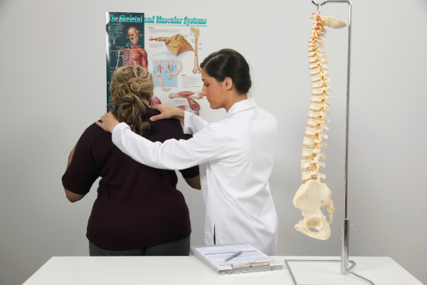 Chiropractor performing spinal adjustment